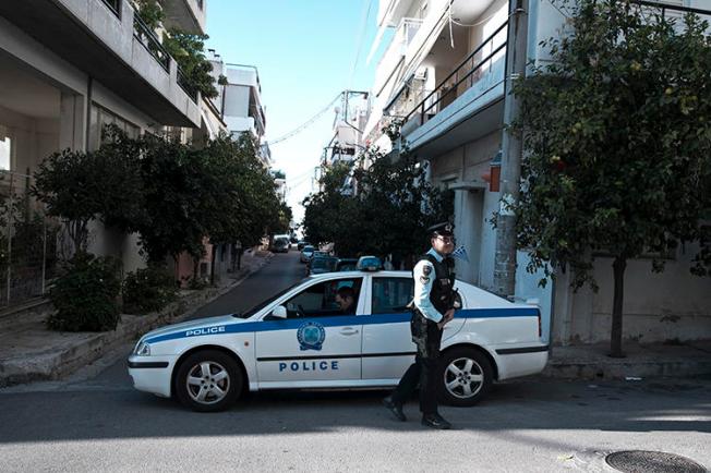 Police officers are seen in Athens, Greece, on November 13, 2018. CNN Greek reporter Mina Karamitrou's car was recently destroyed by a bomb in an Athens suburb. (AP/Petros Giannakouris)