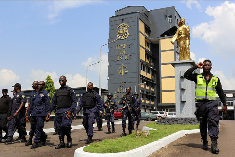 Policemen are seen at the Temple of Justice in Monrovia, Liberia, on December 7, 2017. Journalists from local radio station Roots FM were recently sued for $500,000 in a civil defamation suit by the Liberian minister of state for presidential affairs. (Reuters/James Giahyue)