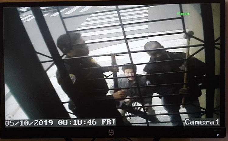 Security camera footage shows police during a raid on the home of freelancer Bryan Carmody, in San Francisco, on May 10. Officers confiscated electronic devices and documents. (Bryan Carmody)