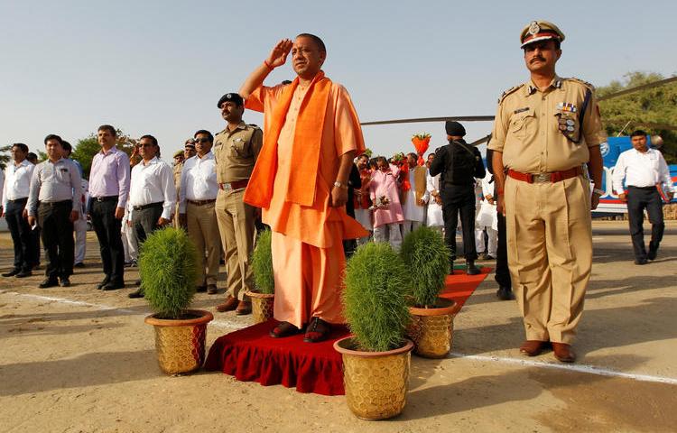 Yogi Adityanath, chief minister of India's most populous state, Uttar Pradesh, salutes as he inspects an honor guard during a visit to Allahabad, India, June 3, 2017. REUTERS/Jitendra Prakash