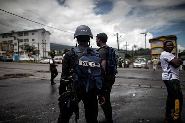 Cameroonian police officers are seen on October 3, 2018. Police recently arrested journalist Paul Chouta on criminal defamation and false news charges. (AFP/Marco Longari)