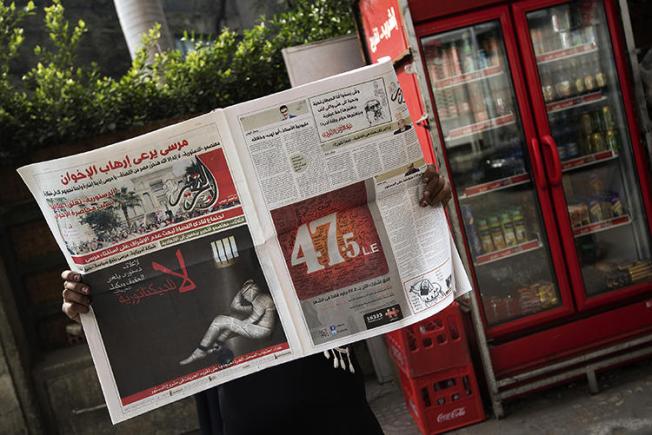 A copy of Egyptian newspaper al-Tahrir is seen in Cairo on December 3, 2012. The newspaper is facing insolvency after its website was blocked in May. (AFP/Gianluigi Guercia)