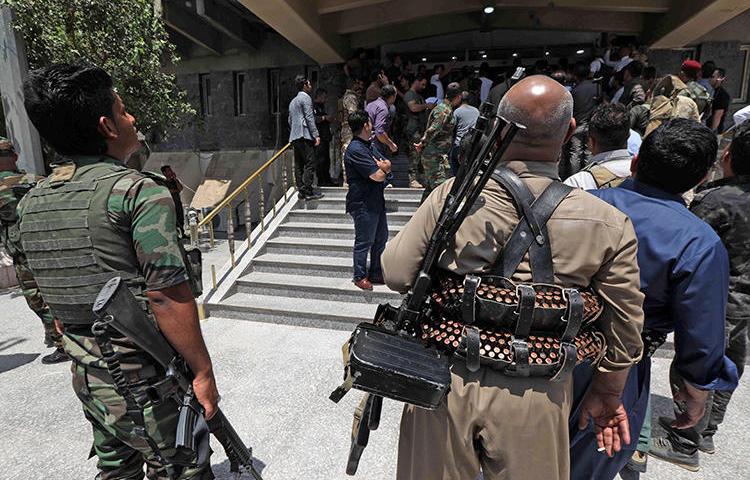 Kurdish security forces are seen in Erbil, Iraqi Kurdistan, on July 23, 2018. Security forces recently harassed and attempted to arrest journalist Barzan Ali Hama. (AFP/Safin Hamed)