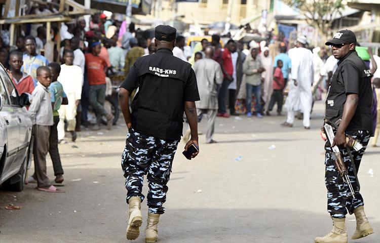 Federal Special Anti-Robbery Squad officers are seen in Kano, Nigeria, on February 23, 2019. Journalist Kofi Bartels told CPJ he was recently assaulted and threatened by anti-robbery officers. (AFP/Pius Utomi Ekpei)