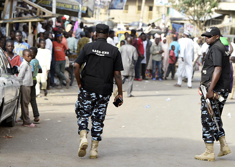 Federal Special Anti-Robbery Squad officers are seen in Kano, Nigeria, on February 23, 2019. Journalist Kofi Bartels told CPJ he was recently assaulted and threatened by anti-robbery officers. (AFP/Pius Utomi Ekpei)