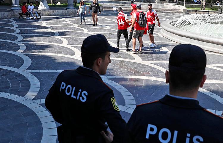 Police officers are seen in Baku, Azerbaijan, on May 29, 2019. Azerbaijani authorities recently jailed two journalists in unrelated cases. (AP/Darko Bandic)