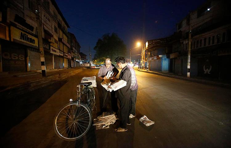 Newspaper vendors collect copies of the papers in Srinagar, in July 2016. The Kashmir Times, one of the oldest papers in Indian-controlled Jammu and Kashmir, is suffering under a nearly 10-year ban on government advertising. (AP/Mukhtar Khan)