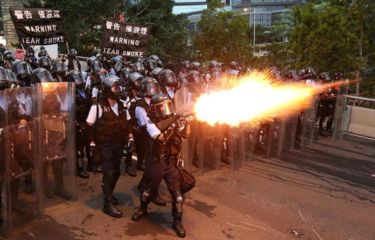 Police officers fire tear gas in Hong Kong on June 12, 2019. CPJ has called on Hong Kong authorities to investigate police actions against journalists during the city's ongoing protests. (Reuters/Athit Perawongmetha)