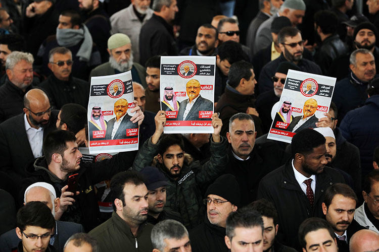 People holding pictures of murdered Saudi journalist Jamal Khashoggi during a symbolic funeral prayer held in Istanbul, Turkey on November 16, 2018. (REUTERS/Huseyin Aldemir)