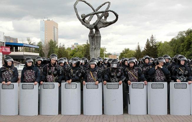 Kazakh police block an area to prevent protests against presidential elections in Nur-Sultan, the capital city of Kazakhstan, on June 10, 2019. Local internet users are being asked to download a security certificate that could allow the authorities to monitor or censor encrypted websites. (AP Photo/Alexei Filippov)