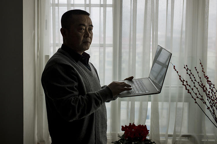 Chinese journalist Huang Qi is seen in Chengdu, Sichuan province, on January 22, 2015. Today, Huang was sentenced to 12 years in prison. (AFP/Fred Dufour)