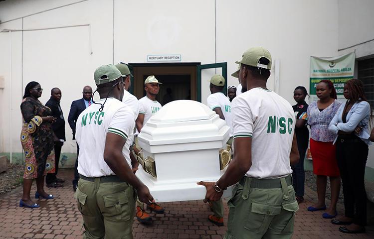 Members of National Youth Service Corp carry the body of their colleague, the reporter Precious Owolabi, in Abuja on July 23. Owolabi was shot while covering protests in the Nigeria capital. (AFP/Kola Sulaimon)
