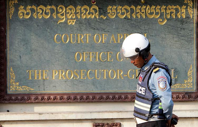 A police officer is seen in Phnom Penh, Cambodia, on February 1, 2018. Two Cambodian journalists were recently arrested and face incitement charges for live-streaming a protest. (AP/Heng Sinith)