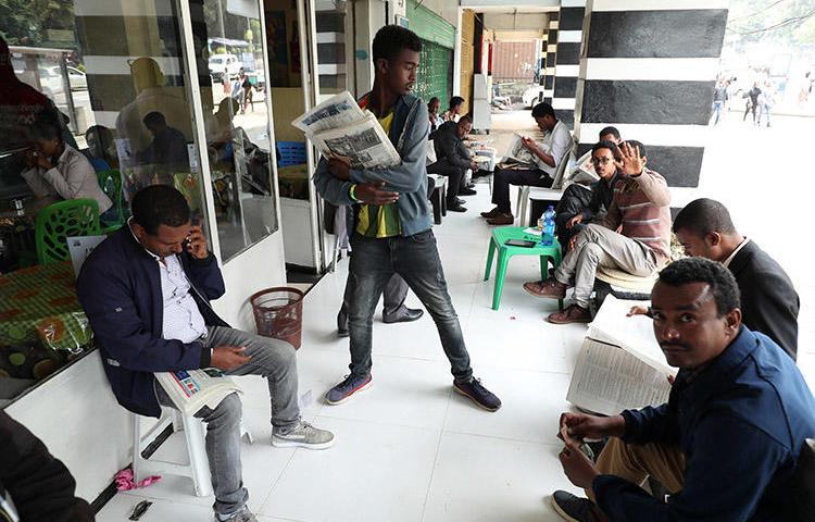 Ethiopians read newspapers in Addis Ababa on June 24. Following what the government refers to as a failed attempted coup, access to the internet was cut and journalists were arrested. (Reuters/Tiksa Negeri)