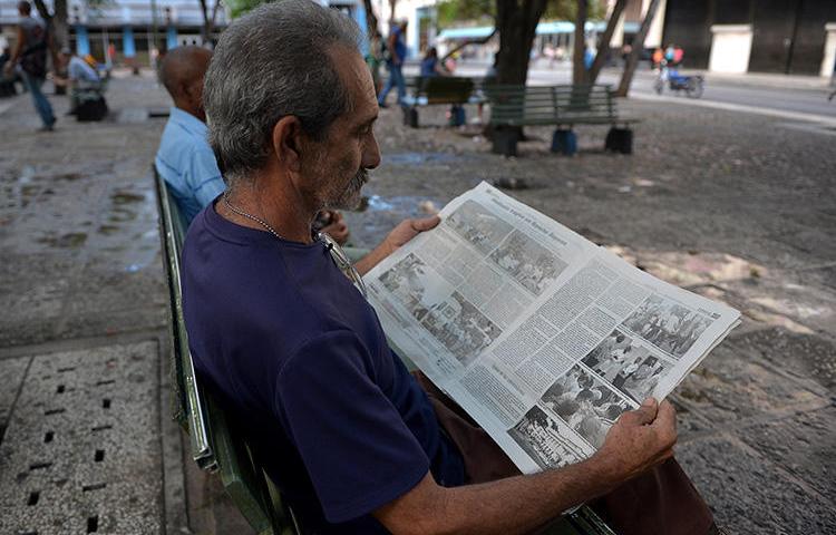 A man reads a Cuban newspaper in Havana on May 19, 2018. Cuba sentences journalist Roberto Quiñones to one-year prison term on August 7, 2019. (AFP/Yamil Lage)