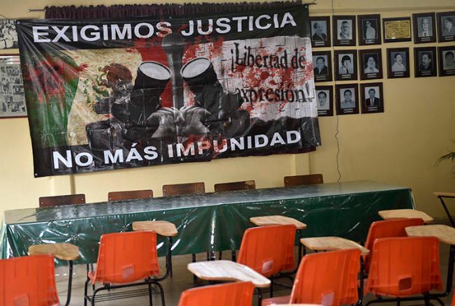 A sign reading 'We demand justice. No more impunity' hangs at the journalists' union office in Chilpancingo, Guerrero state, in May 2017. Two journalists from the state were killed within days of each other this week. (AFP/Pedro Pardo)