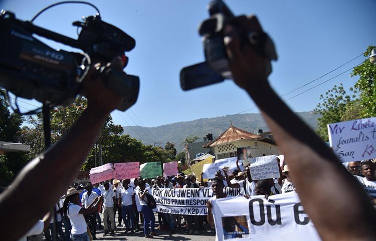 Des reporters haïtiens et d’autres personnes manifestent à Port-au-Prince le 28 mars 2018 pour réclamer des informations sur le photojournaliste disparu Vladimir Legagneur. Un autre journaliste, Luckson Saint-Vil, a été la cible de tirs dans le sud d’Haïti le 6 août 2019. (AFP/Hector Retamal)