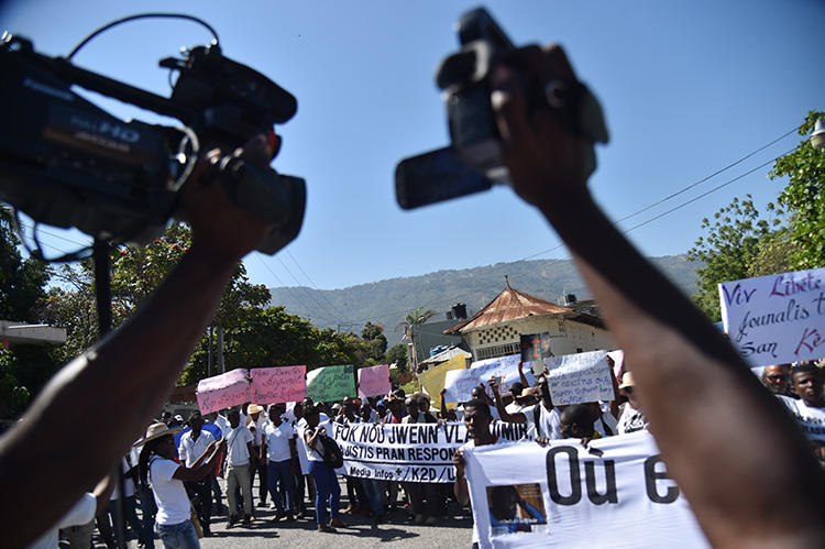 Haitian reporters and others protest in Port-au-Prince on March 28, 2018, calling for information on missing photojournalist Vladimir Legagneur. Another journalist, Luckson Saint-Vil, was shot at in southern Haiti on August 6, 2019. (AFP/Hector Retamal)