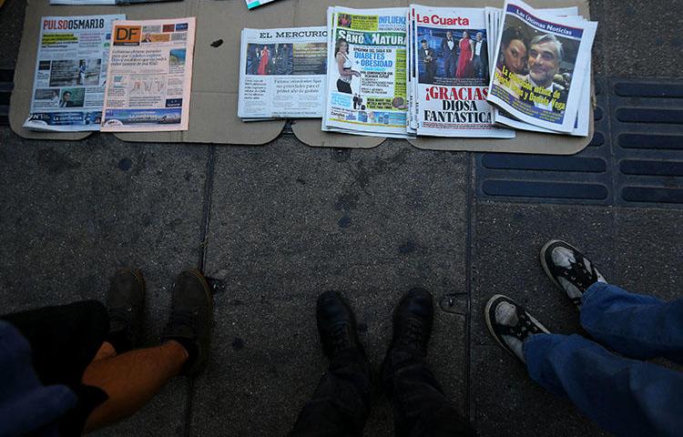 Newspapers are sold on a sidewalk in Santiago in March 2018. Chile’s army allegedly ordered a surveillance operation against the investigative journalist Mauricio Weibel Barahona in 2016. (Reuters/Ivan Alvarado)