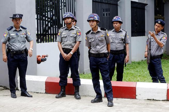 Police stand guard outside a court in Yangon, Myanmar, on August 9, 2019. The Mandalay District Court recently agreed to hear an appeal that could reopen a criminal defamation lawsuit against editor Swe Win. (Reuters/Ann Wang)