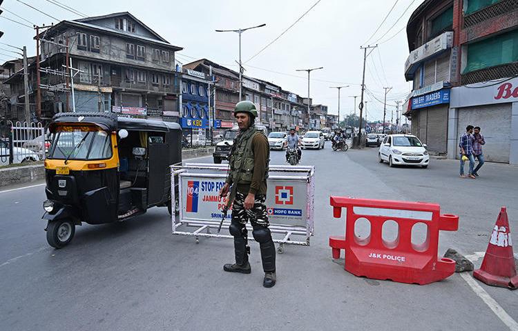An Indian paramilitary trooper stands guard on a road in Srinagar, Kashmir's largest city, on September 7, 2019. Since the government stripped the region of its limited autonomous status and imposed a communication blackout in early August, Kashmir’s news media has faced a deep existential crisis. (AFP/Tauseef Mustafa)