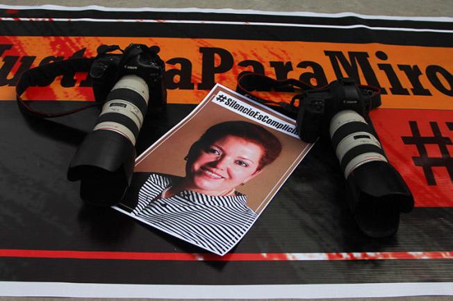Cameras and a photo of Miroslava Breach are laid out as part of a tribute to the journalist on the second anniversary of her murder. Mexico's investigation into her killing is flawed, a report on the journalist has found. (AFP/Herika Martinez)