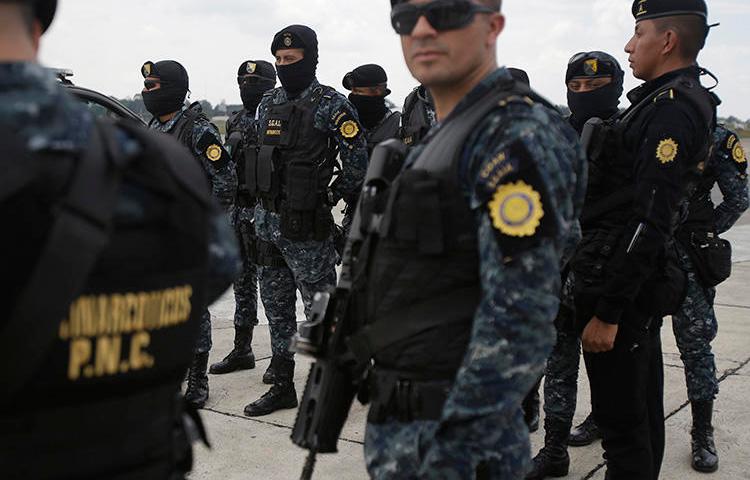 Police officers are seen in Guatemala City on May 20, 2019. Police in El Estor recently raided the Mayan Xyaab’ Tzuultaq’a radio station. (AP/Moises Castillo)