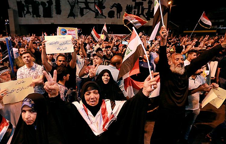 Iraqi protesters chant slogans during a demonstration in Tahrir Square in central Baghdad, Iraq, on June 21, 2019. Iraq suspended U.S.-funded broadcaster Al-Hurrah for 3 months over a corruption report on September 2. (AP Photo/Hadi Mizban)