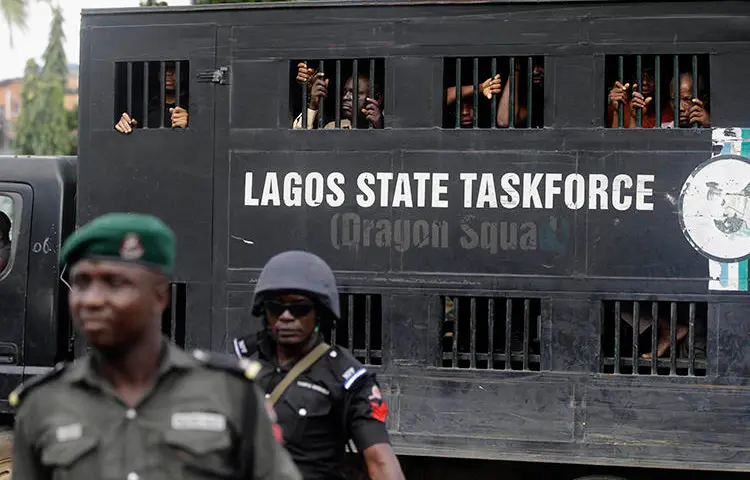 Police officers are seen in Lagos, Nigeria, on August 5, 2019. Lagos police recently arrested publisher Agba Jalingo, who has been charged by federal authorities with treason. (AP/Sunday Alamba)