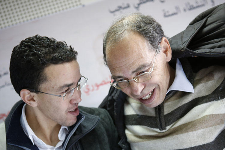 Maati Monjib, right, chats with Moroccan journalist Hicham Mansouri in Rabat, Morocco, January 17, 2016. Amnesty International reported this month that Monjib has been sent malicious messages in an attempt to install spyware on his phone. (AP Photo/Abdeljalil Bounhar)