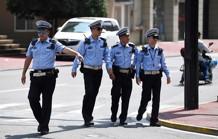 Police officers are seen in Shanghai on July 30, 2019. Police in Guangzhou recently arrested journalist Sophia Huang Xueqin. (AP/Greg Baker)
