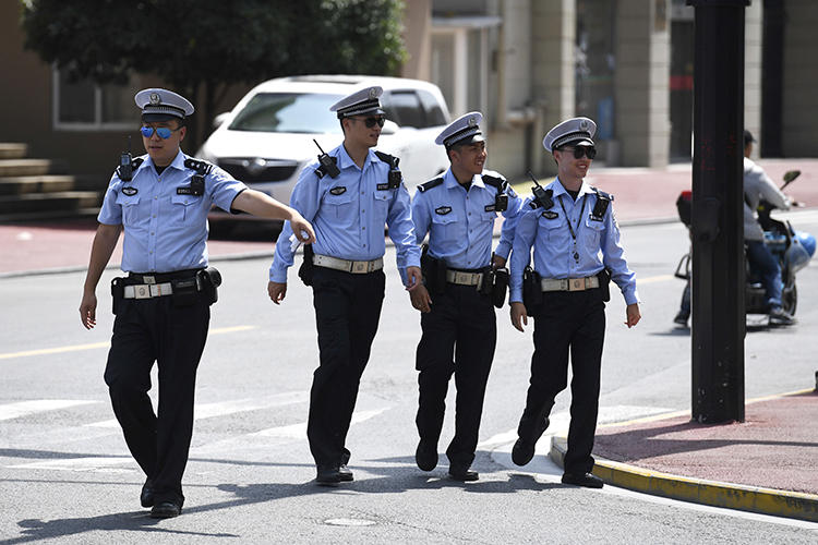 Police officers are seen in Shanghai on July 30, 2019. Police in Guangzhou recently arrested journalist Sophia Huang Xueqin. (AP/Greg Baker)