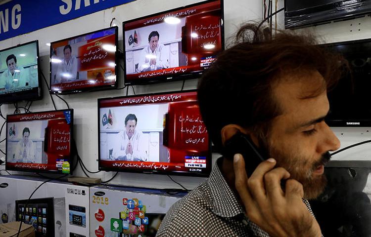 News broadcasts are seen on televisions in Karachi, Pakistan, on July 26, 2018. The country's media regulator recently issued mixed messages regarding news anchors' abilities to express their opinions. (Reuters/Akhtar Soomro)