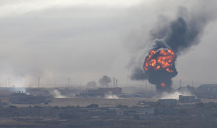 An explosion is seen over the Syrian town of Ras al-Ain on October 12, 2019. Turkish airstrikes near Ras al-Ain recently killed two journalists. (Reuters/Stoyan Nenov)
