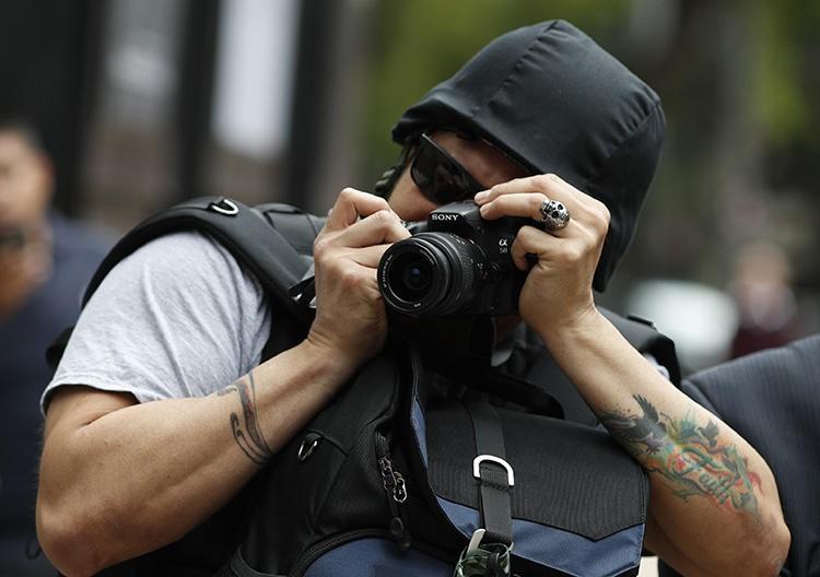 A photographer takes pictures of a protest against the murder and disappearances of journalists in Mexico, in Mexico City on August 21, 2019. (AP/Rebecca Blackwell)