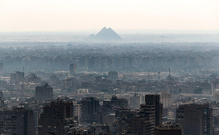 A view of Giza Pyramids, taken from Cairo Tower on October 23, 2019. Security officers raided the Cairo offices of Mada Masr on November 24 and detained three staff. (AFP/Mohamed el-Shahed)