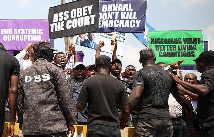 Demonstrators are seen outside the Department of State Services headquarters in Abuja, Nigeria, on November 12, 2019. Police fired on and attacked journalists covering that demonstration. (AFP/Kola Sulaimon)