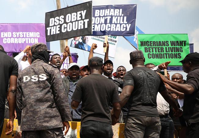Demonstrators are seen outside the Department of State Services headquarters in Abuja, Nigeria, on November 12, 2019. Police fired on and attacked journalists covering that demonstration. (AFP/Kola Sulaimon)
