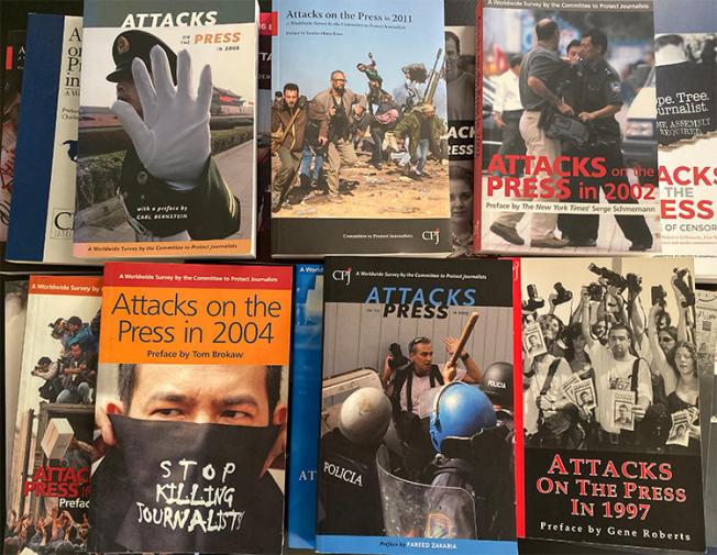 Covers of CPJ's 'Attacks on the Press' books. Starting in 1987, the annual publication acted as a database of press freedom violations. (CPJ/Mustafa Hameed)