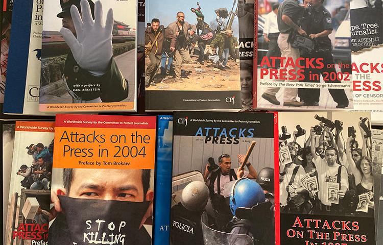 Covers of CPJ's 'Attacks on the Press' books. Starting in 1987, the annual publication acted as a database of press freedom violations. (CPJ/Mustafa Hameed)