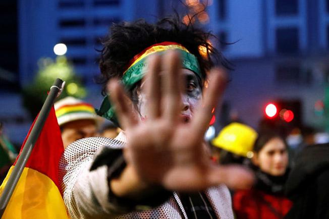 A demonstrator gestures during a protest in La Paz on November 9, 2019. Several news outlets were attacked and threatened over the weekend, following unrest that led to the resignation of President Evo Morales. (Reuters/Kai Pfaffenbach)