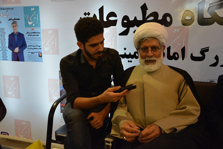 Pouyan Khoshhal pictured during an interview with Mohsen Rohami, an Iranian lawyer, cleric and reformist politician, in 2016. Khoshhal says he had to censor himself constantly while reporting in Iran. (Pouyan Khoshhal)