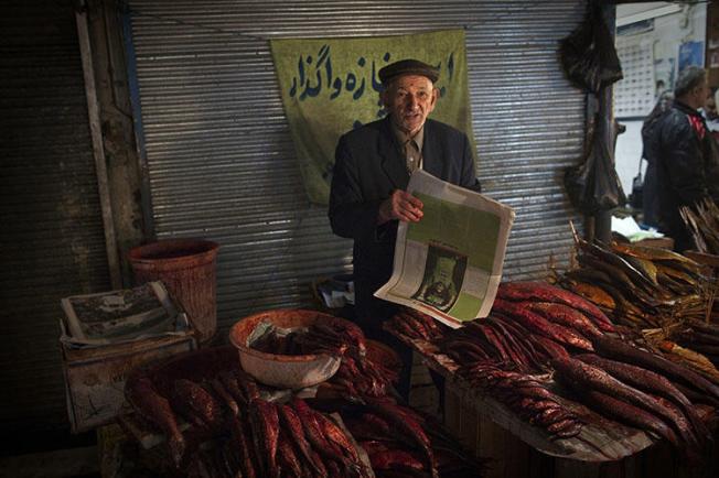 A fishmonger pictured at a bazaar in the Iranian city of Rasht, in March 2011. In 2018, Turkey extradited a journalist from Rasht whom authorities later sentenced to 10 years in prison for his work. (AFP/Behrouz Mehri)