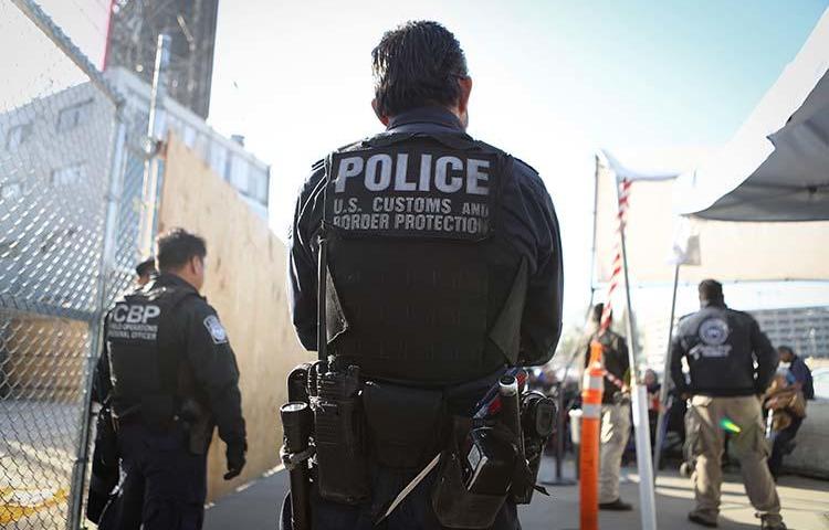A U.S. Customs and Border Protection officer waits for pedestrians entering the United States on April 9, 2018 at the San Ysidro port of entry in California. Warrantless searches of devices belonging to journalists and other travelers at the border violate the U.S. constitution, a Massachusetts district court judge ruled in November. (Getty Images/AFP/Mario Tama)