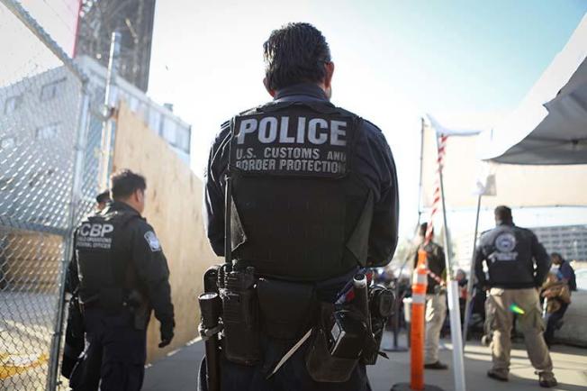 A U.S. Customs and Border Protection officer waits for pedestrians entering the United States on April 9, 2018 at the San Ysidro port of entry in California. Warrantless searches of devices belonging to journalists and other travelers at the border violate the U.S. constitution, a Massachusetts district court judge ruled in November. (Getty Images/AFP/Mario Tama)