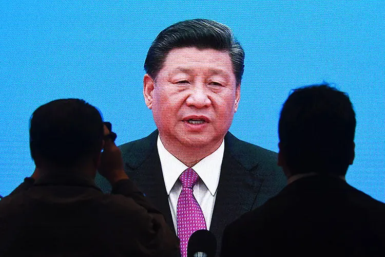 Journalists watch a live image of Chinese President Xi Jinping giving a briefing at the end of the final day of the Belt and Road Forum, at the media center in Beijing on April 27, 2019. (AFP/Greg Baker)