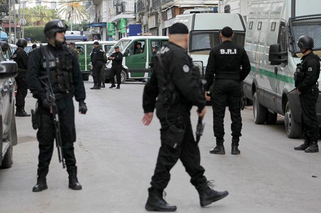 Algerian security forces are seen in Algiers on December 4, 2019. Authorities recently sentenced cartoonist Benabdelhamid Amine to three months in prison. (AP/Toufik Doudou)