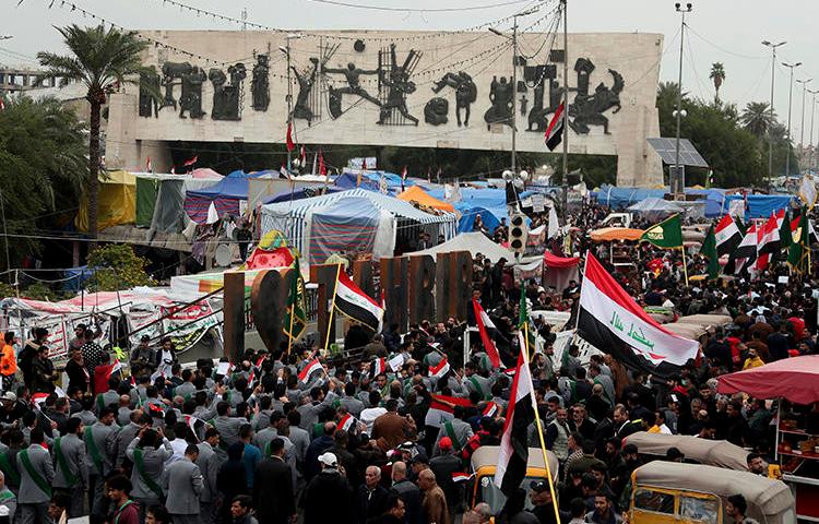 Demonstrators are seen in Tahrir Square in Baghdad, Iraq, on December 6, 2019. One journalist was killed and another went missing after covering protests on December 6. (AP/Hadi Mizban)