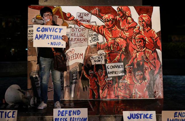 A relative of one of the Maguindanao massacre victims addresses the crowd during a rally to call for justice in Quezon city, on December 18, 2019. A Philippines court today issued its verdict on the 2009 attack, in which 58 people, including 32 journalists and media workers, were killed. (AP/Aaron Favila)