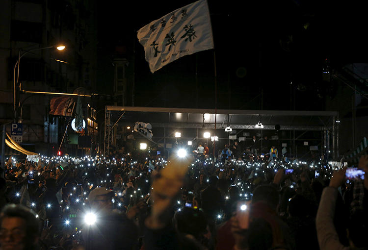 Supporters of Democratic Progressive Party (DPP) Chairperson and presidential candidate Tsai Ing-wen hold up their mobile phones as they celebrate Tsai's election victory in Taipei, Taiwan, on January 16, 2016. (Reuters/Pichi Chuang)